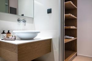 a bathroom with a white sink on a counter at Apollon City Suites in Kos