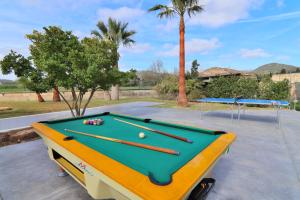 a pool table in a parking lot with two tables at Villa Can Mussol 040 by Mallorca Charme in Sa Pobla