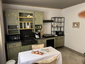 a kitchen with a table with a white table cloth at B&B Els 