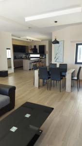 a living room with a table and chairs at Trilogy, Ample Penthouse, Gozo in Kerċem