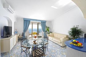 a living room with a glass table and a couch at Alba di Praiano in Praiano