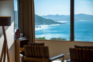 a room with a large window looking at the ocean at Jukaitei in Kyotango