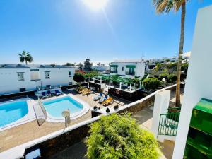 an aerial view of a resort with a swimming pool at Relaxing upper floor Apartment- exclusive complex. in Los Pocillos