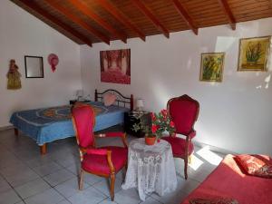 a bedroom with a bed and two chairs and a table at Rianna Studio in Theologos