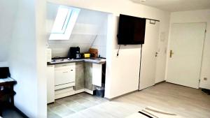 a small kitchen with a refrigerator and a window at Tolle Wohnung in bester Lage von Heidenheim in Heidenheim an der Brenz
