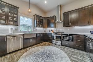 a large kitchen with wooden cabinets and a rug at Mojo's Dojo in McKinleyville