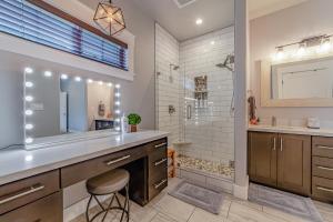a bathroom with a sink and a shower with a mirror at Mojo's Dojo in McKinleyville