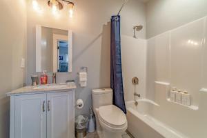 a bathroom with a toilet and a sink and a shower at Mojo's Dojo in McKinleyville
