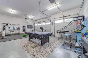 a garage with a ping pong table and a net at Mojo's Dojo in McKinleyville