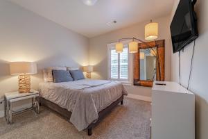 a bedroom with a bed and a tv and a mirror at Mojo's Dojo in McKinleyville