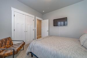 a bedroom with a bed and a chair and a television at Mojo's Dojo in McKinleyville