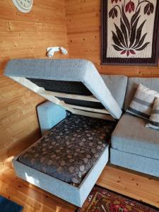 a couch and a chair in a room at Villa Okra in Rastinniemi