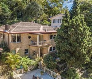 an aerial view of a house with a tree at Gracious 1930s Art Deco House in Gosford