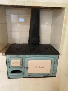 an old green stove in a tiled wall at Gracious 1930s Art Deco House in Gosford