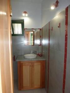 a bathroom with a sink and a mirror at Cottage na Ribeira do Paúl in Pombas