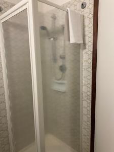 a shower with a glass door in a bathroom at Hotel Gli Ulivi in Soverato Marina