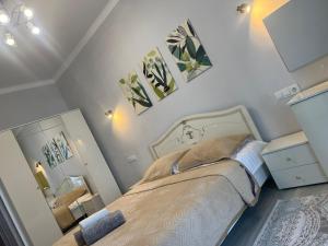 a bedroom with a bed and a mirror at ЖК Champion in Astana