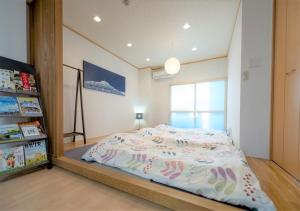 a bedroom with a bed with a large mirror at HOSTEL PAQ tokushima in Tokushima