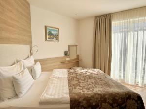 a hotel room with a bed and a window at Boutique Hotel Grahor in Sežana