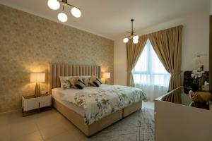 a bedroom with a large bed and a window at INA Homes-Residences Tower 7 Full Burj Khalifa & Fountain Views in Dubai