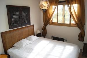 a bedroom with a white bed and a window at Luxury 1 bedroom private apartment - Dog friendly! in Finestrat