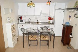 a kitchen with a glass table with chairs in it at Luxury 1 bedroom private apartment - Dog friendly! in Finestrat