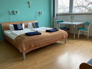 a bedroom with a bed with two blue pillows on it at Hostel Stralsund in Stralsund +60 photos