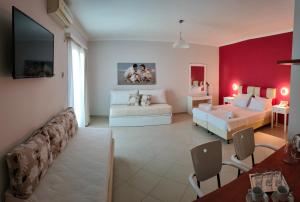 a large room with two beds and a living room at Valena Studios in Nydri