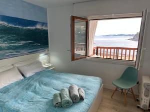 a bedroom with a bed and a large window at BURUMENDI 4 in Mutriku