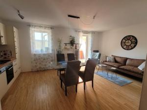 a living room with a table and a couch at Studios Am Wienerwald in Hinterbrühl