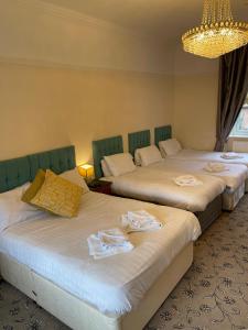 a room with two beds with towels on them at The Old Rectory in Jarrow