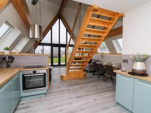 a kitchen with a staircase and a dining room at Brecknock Cheviot - The Sheepfold in Llandrindod Wells