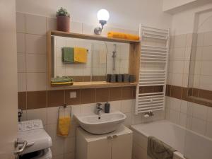 a bathroom with a sink and a bath tub at Studios Am Wienerwald in Hinterbrühl