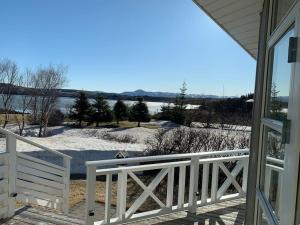 a view from the porch of a house with a white fence at Paradise near Reykjavik w. Sauna - Northern Lights in Mosfellsbær