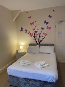 a bedroom with a bed with butterflies on the wall at The Old Rectory in Jarrow