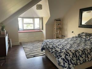 a bedroom with a bed and a window at Stunning Liverpool Apartment in Liverpool