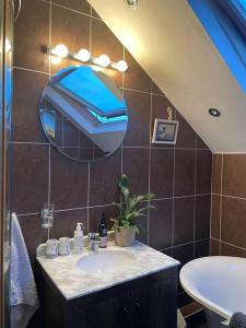 a bathroom with a sink and a mirror at Stunning Liverpool Apartment in Liverpool