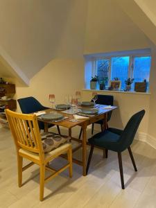 a dining room with a wooden table and chairs at Stunning Liverpool Apartment in Liverpool