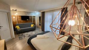 a hotel room with a bed and a couch at Lumiere House Sibiu in Sibiu