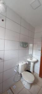 a bathroom with a toilet and a sink at Pousada Nascer da Lua in São Thomé das Letras