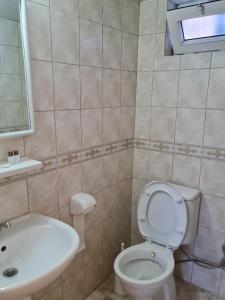 a bathroom with a toilet and a sink at Caner Mountain Hotel in Antalya