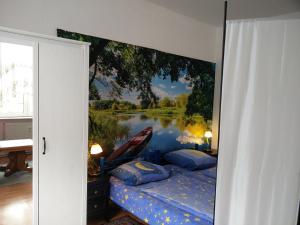 a bedroom with a painting of a boat on the water at Ferienwohnung Zur Weißen Taube in Dobbertin