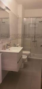 a bathroom with a sink and a shower and a toilet at Villa Rosa in Latte