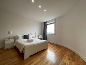 Habitación blanca con cama y ventana en Apartments City Center • Collection by Perpetual Relax en Braga