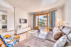 a living room with a couch and a table at Pins 441 Derecha in Playa de Muro