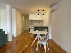 a kitchen and dining room with a table and chairs at Apartments City Center • Collection by Perpetual Relax in Braga
