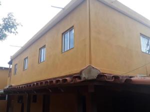 a yellow house with windows on top of it at HOSPEDAGEM DA ROSE 3 in Marataizes