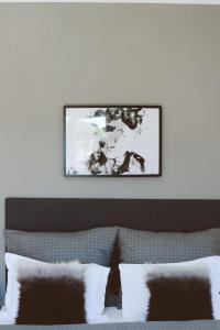 a picture hanging on a wall above a bed at Mediteran Hvar - Modern Rooms and Restaurant, B&B in Vrboska