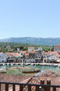 a view of a town from the balcony of a resort at Mediteran Hvar - Modern Rooms and Restaurant, B&B in Vrboska