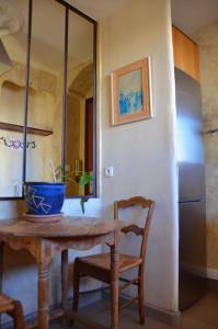 a kitchen with a table and chairs and a refrigerator at Portman cosy in Toulon